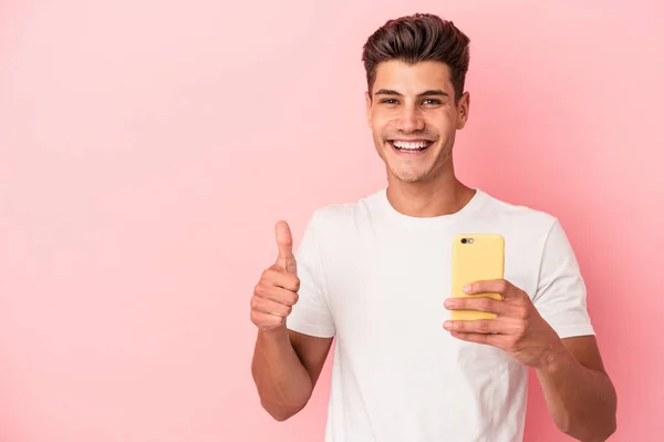 Joven Hombre Caucásico Sosteniendo Teléfono Móvil Aislado Sobre Fondo Rosa —  Fotos de Stock