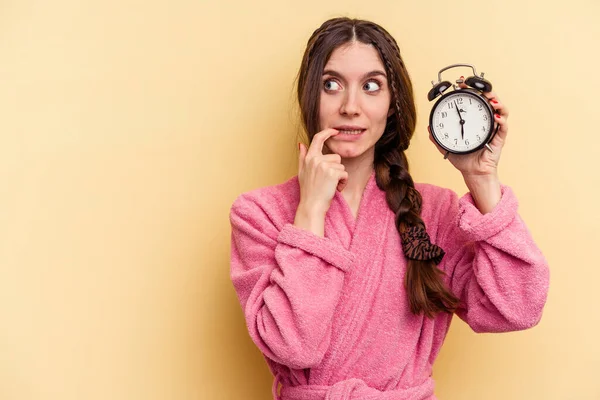 Young Caucasian Woman Wearing Bathrobe Holding Alarm Clock Isolated Yellow — Stock Photo, Image