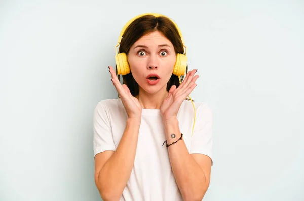 Young English Woman Listening Music Isolated Blue Background Surprised Shocked — Stock Photo, Image