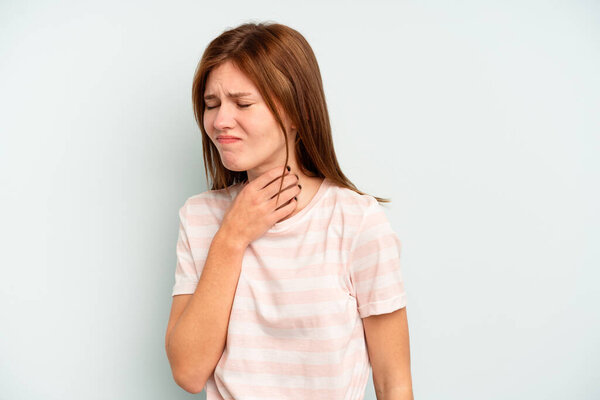 Young English woman isolated on blue background suffers pain in throat due a virus or infection.