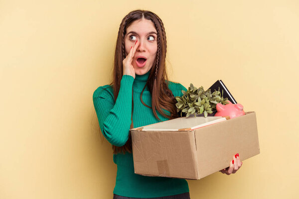 Young caucasian woman making a move isolated on yellow background is saying a secret hot braking news and looking aside