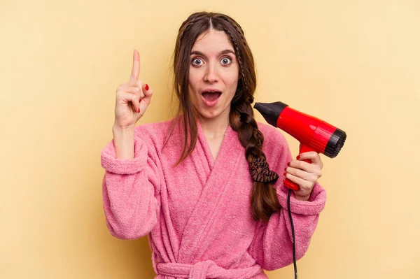 Young Woman Holding Hairdryer Isolated Yellow Background Having Idea Inspiration — Stock Photo, Image