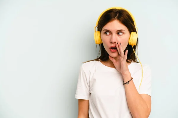 Νεαρή Αγγλίδα Που Ακούει Μουσική Απομονωμένη Μπλε Φόντο Λέει Ένα — Φωτογραφία Αρχείου