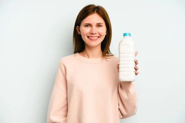 Junge Engländerin Hält Eine Flasche Milch Isoliert Auf Blauem Hintergrund — Stockfoto