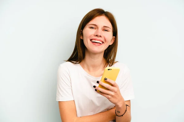 Young English Woman Holding Mobile Phone Isolated Blue Background Laughing — Stock Photo, Image