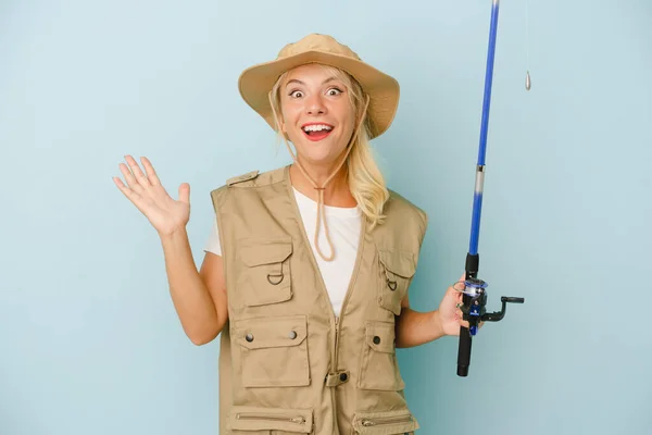 Young Russian Fisherwoman Isolated Blue Background Receiving Pleasant Surprise Excited — Stock Photo, Image