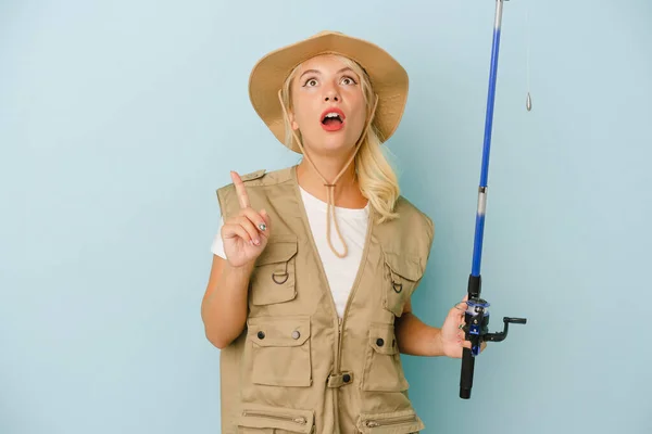 Young Russian Fisherwoman Isolated Blue Background Pointing Upside Opened Mouth — Stock Photo, Image