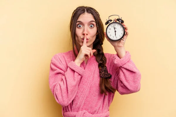 Young Caucasian Woman Wearing Bathrobe Holding Alarm Clock Isolated Yellow — Stock Photo, Image