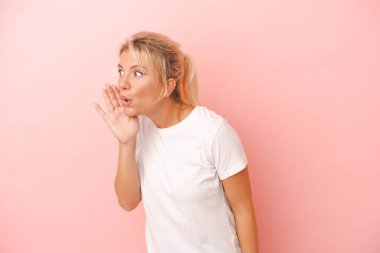 Pembe arka planda izole edilmiş genç bir Rus kadın gizli bir fren haberinin olduğunu söylüyor.