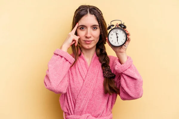 Young Caucasian Woman Wearing Bathrobe Holding Alarm Clock Isolated Yellow — Stock Photo, Image