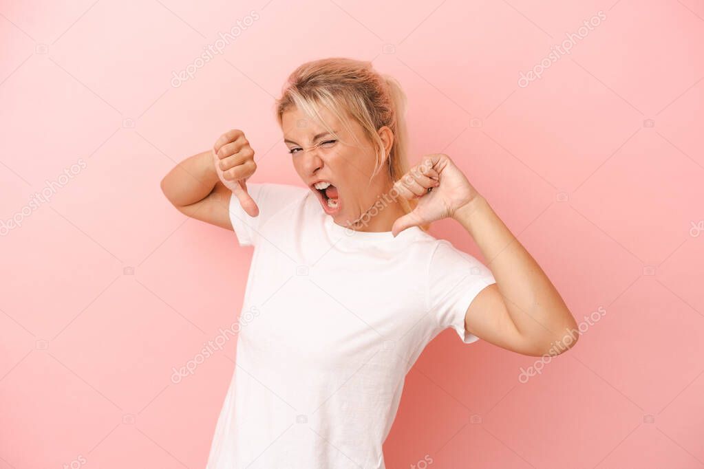 Young Russian woman isolated on pink background feels proud and self confident, example to follow.