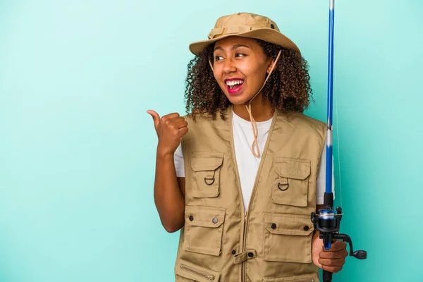 Young African American Fisherwoman Holding Rod Isolated Blue Background Points — Stock Photo, Image