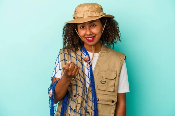 Young African American Fisherwoman Holding Net Isolated Blue Background Pointing — Stock Photo, Image