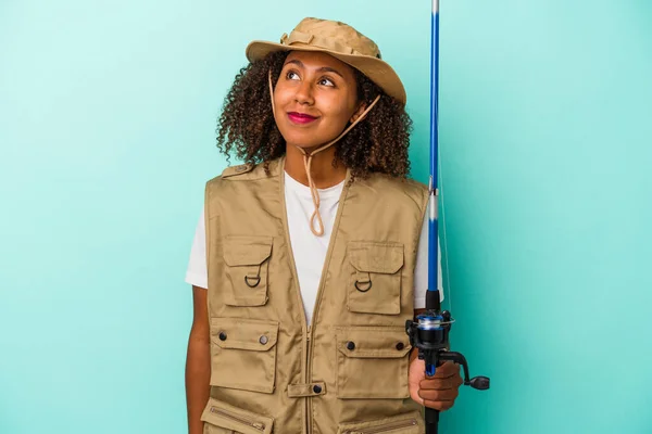 Young African American Fisherwoman Holding Rod Isolated Blue Background Dreaming — Stock Photo, Image