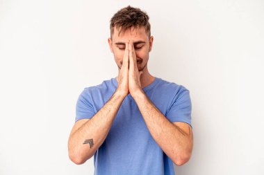 Pembe arka planda soyutlanmış genç beyaz bir adam gülümsüyor, neşeli ve keyifli görünüyor..