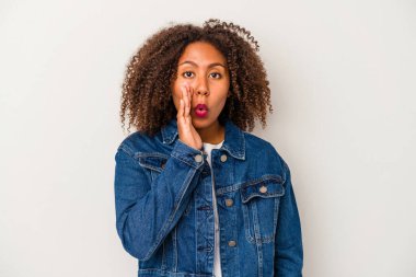 Beyaz arka planda izole edilmiş kıvırcık saçlı Afro-Amerikalı genç bir kadın gizli bir sıcak fren haberi veriyor ve bir kenara bakıyor.