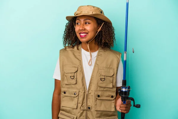 Young African American Fisherwoman Holding Rod Isolated Blue Background Looks — Stock Photo, Image