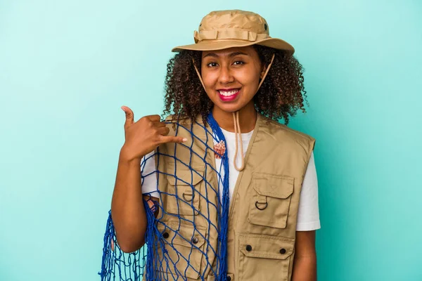 Young African American Fisherwoman Holding Net Isolated Blue Background Showing — Stock Photo, Image