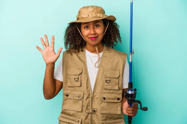 Young African American Fisherwoman Holding Rod Isolated Blue Background Smiling — Stock Photo, Image