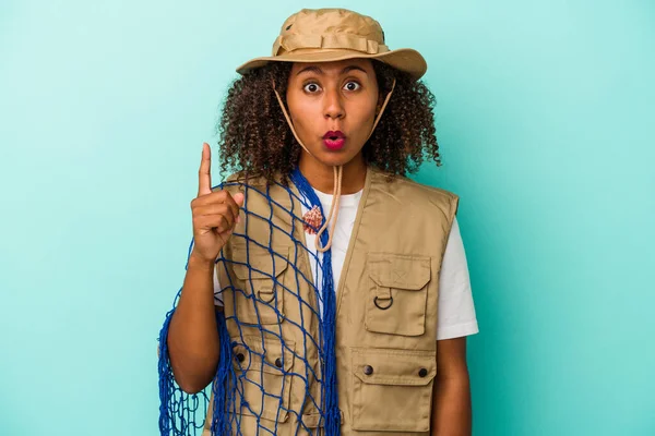 Young African American Fisherwoman Holding Net Isolated Blue Background Having — Stock Photo, Image