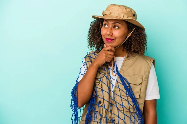 Young African American Fisherwoman Holding Net Isolated Blue Background Looking — Stock Photo, Image