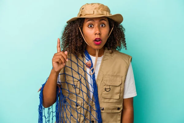 Young African American Fisherwoman Holding Net Isolated Blue Background Having — Stock Photo, Image