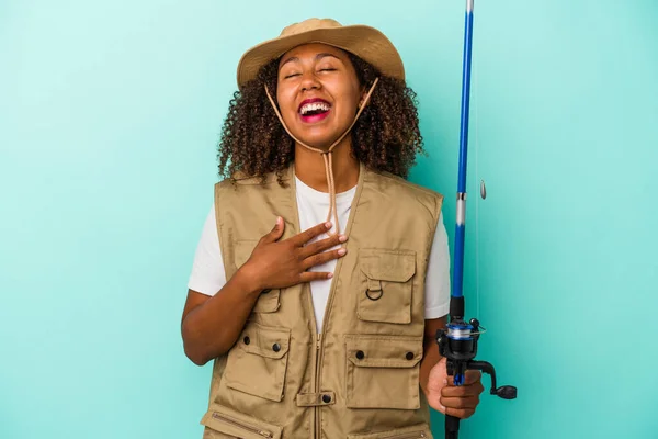 Young African American Fisherwoman Holding Rod Isolated Blue Background Laughs — Stock Photo, Image