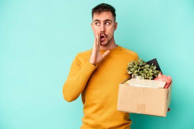 Kafkasyalı genç bir adam mavi arka planda izole edilmiş bir şekilde hareket ediyor. Gizli bir sıcak fren haberi veriyor ve yana bakıyor.