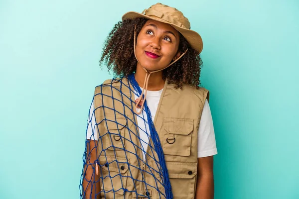 Young African American Fisherwoman Holding Net Isolated Blue Background Dreaming — Stock Photo, Image
