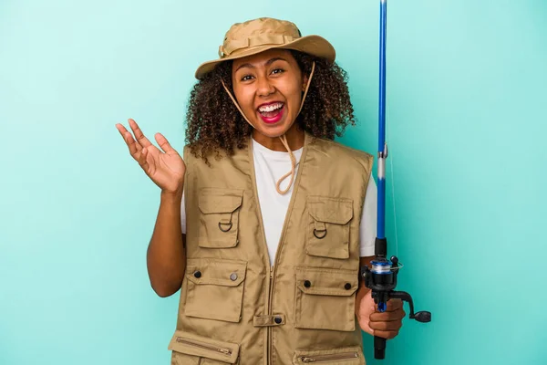 Young African American Fisherwoman Holding Rod Isolated Blue Background Receiving — Stock Photo, Image