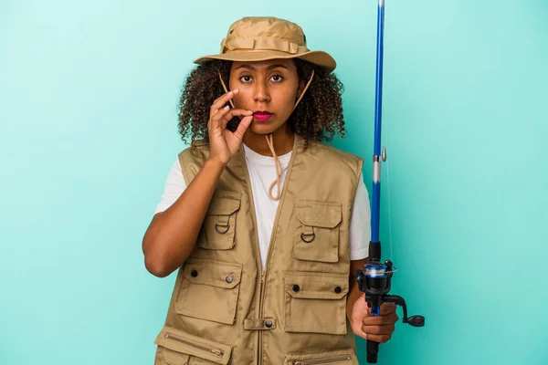 Young African American Fisherwoman Holding Rod Isolated Blue Background Fingers — Stock Photo, Image