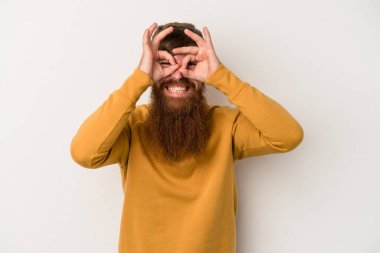 Beyaz arka planda uzun sakallı, beyaz tenli, beyaz tenli genç, beyaz bir adam heyecanlı..