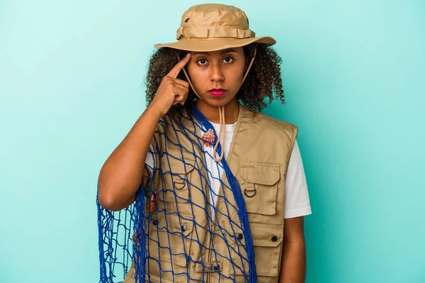 Young African American Fisherwoman Holding Net Isolated Blue Background Pointing — Stock Photo, Image