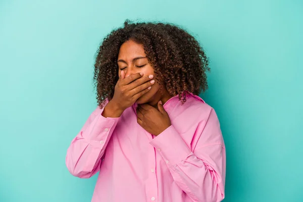 青の背景に孤立した巻き毛を持つ若いアフリカ系アメリカ人女性は ウイルスや感染症のために喉の痛みを受ける — ストック写真