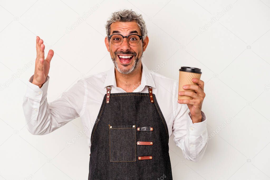 Middle age store clerk holding a take away coffee isolated on white background  receiving a pleasant surprise, excited and raising hands.