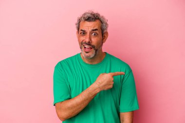Pembe arka planda izole edilmiş orta yaşlı beyaz bir adam.