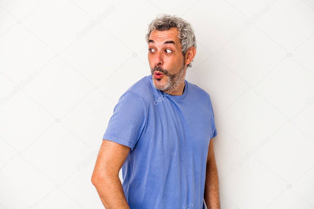 Middle age caucasian man isolated on white background  looks aside smiling, cheerful and pleasant.