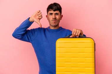 Genç melez adam pembe arka planda izole bir şekilde seyahat edecek. Hoşlanmadığı bir hareket gösterecek. Anlaşmazlık konsepti.