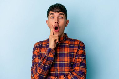 Genç melez adam mavi arka planda izole edildi. Harika bir fikri var, yaratıcılık kavramı..