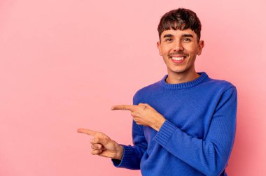 Genç melez adam, pembe arka planda izole edilmiş..