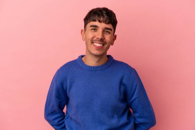 Genç melez adam pembe arka planda izole edilmiş mutlu, güler yüzlü ve neşeli.