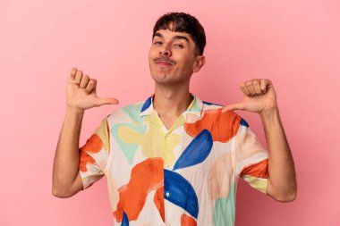 Pembe arka planda soyutlanmış genç melez adam gururlu ve kendinden emin hissediyor, örnek olarak..