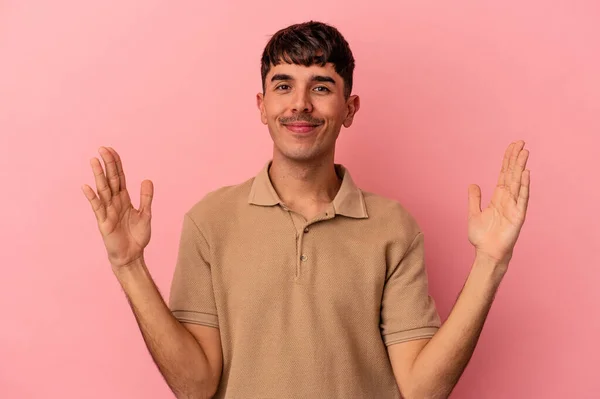 Young Mixed Race Man Isolated Pink Background Holding Something Little — Stock Photo, Image