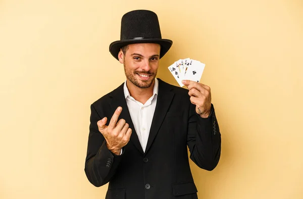 Young Caucasian Wizard Holding Magic Card Isolated Yellow Background Pointing — Stock Photo, Image