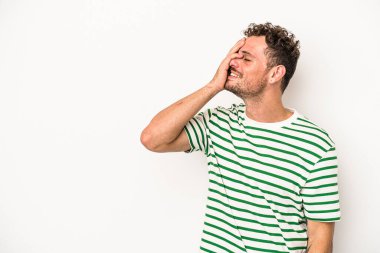 Beyaz arka planda izole olmuş genç beyaz bir adam gülüyor, kaygısız, doğal bir duygu..