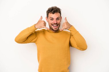 Beyaz arka planda izole edilmiş genç beyaz bir adam parmakları olan bir cep telefonu hareketi gösteriyor..