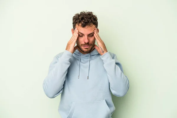 Young Caucasian Man Isolated Green Background Having Head Ache Touching — Stock Photo, Image