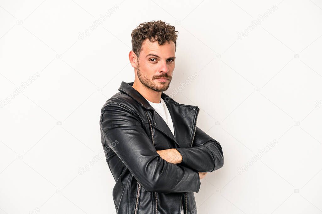 Young caucasian man isolated on white background frowning face in displeasure, keeps arms folded.