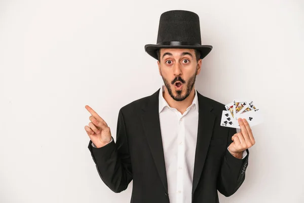 Young Magician Man Holding Magic Card Isolated White Background Pointing — Stock Photo, Image