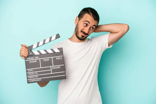 Young Caucasian Actor Man Holding Clapperboard Isolated Blue Background Touching — Stock Photo, Image